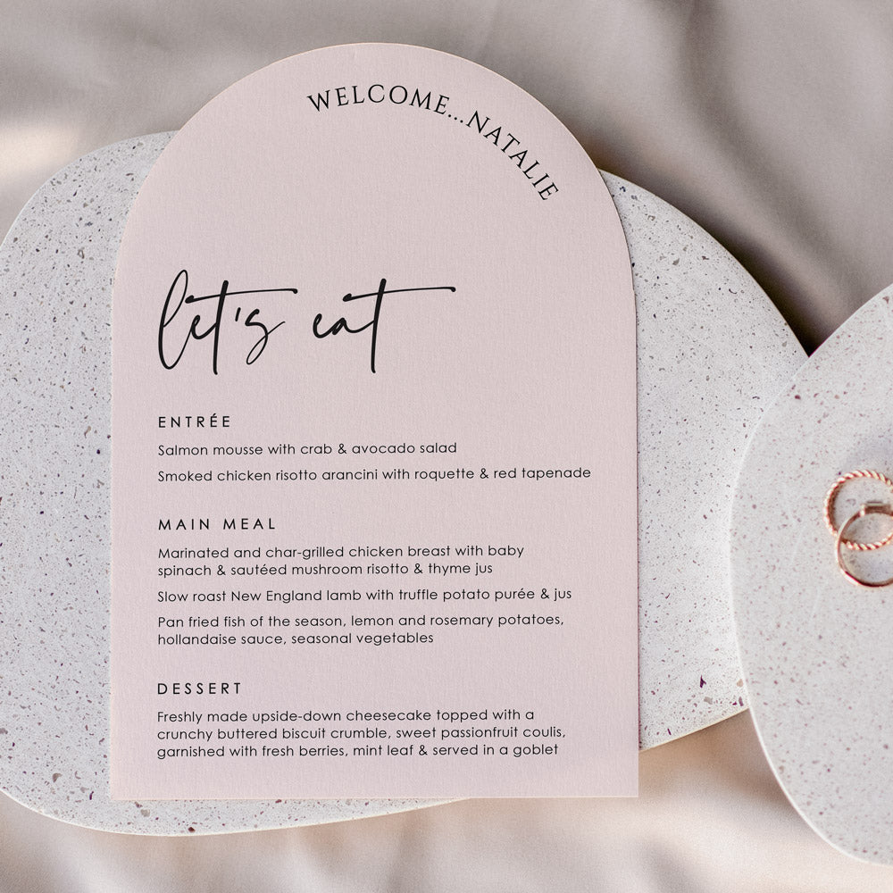 Modern arch shape wedding menu with guest name printing and lets eat for heading. Designed and printed in Australia
