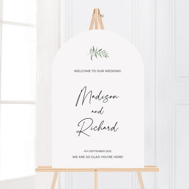 Modern wedding or event welcome sign with watercolour green leaf and calligraphy font. Designed and printed in Australia. Arch shape