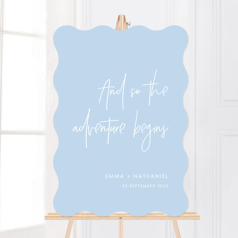 Pale blue and white wedding welcome sign. Wavy shape so the adventure begins. Designed and printed in Australia on foamboard or acrylic.