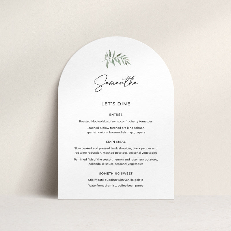 Arch shape wedding menu with green watercolour leaf and modern calligraphy font. Guest names on each, printed in Australia.
