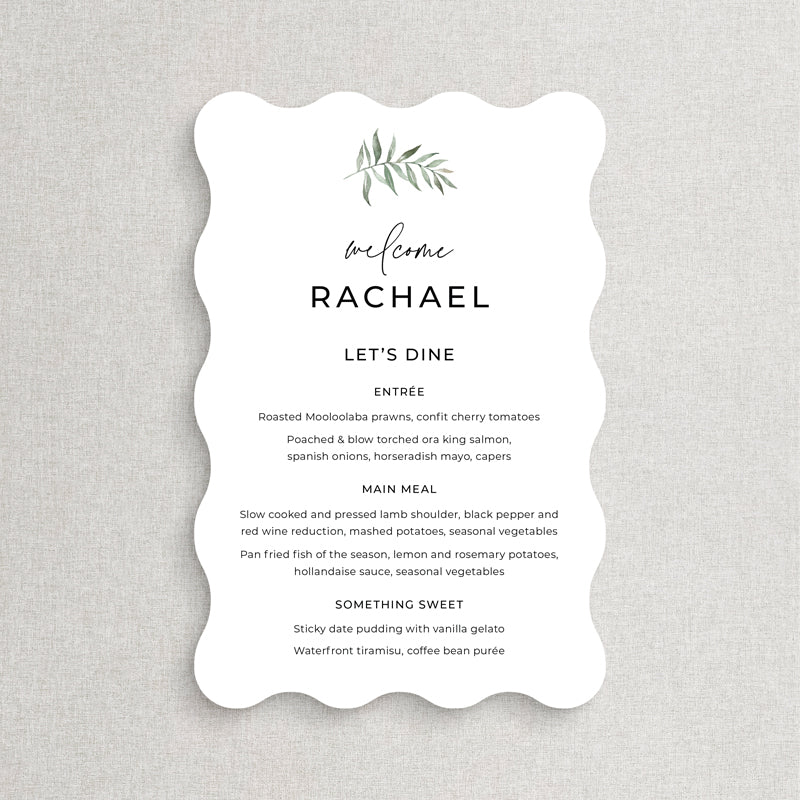 Wavy shape wedding menu with green watercolour leaf and modern calligraphy font. Guest names on each, printed in Australia.
