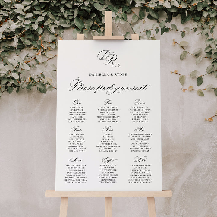 Traditional calligraphy wedding seating chart or guest name plan with monogram of bride and grooms initials. Black and white and printed in Australia.