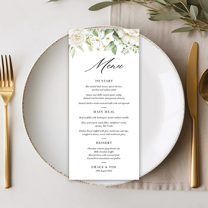 Wedding menu with white florals and green leaves with traditional calligraphy font, professionally printed in Australia.